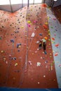 Boy practicing rock climbing in fitness studio Royalty Free Stock Photo