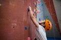 Boy practicing rock climbing in fitness studio Royalty Free Stock Photo