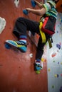 Boy practicing rock climbing in fitness studio Royalty Free Stock Photo