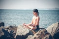 Boy practising yoga on beach Royalty Free Stock Photo