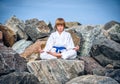 Boy practising yoga on beach Royalty Free Stock Photo