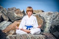 Boy practising yoga on beach Royalty Free Stock Photo