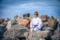 Boy practising yoga on beach Royalty Free Stock Photo