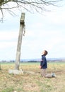 Boy praying by cross with Jesus