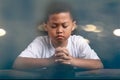 Boy Praying To God At Home