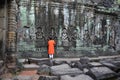 Boy prays at the Buddha wall in Cambodia Royalty Free Stock Photo