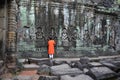 Boy prays at the Buddha wall in Cambodia