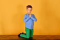 A boy prays kneeling, religious and devout children Royalty Free Stock Photo
