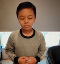boy prays while standing Royalty Free Stock Photo
