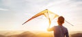 Boy prepare start to fly a kite over the sunset mountain hills Royalty Free Stock Photo