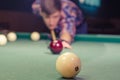 Boy preparing for shot the billiard ball with number ten 10