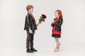 boy presenting roses bouquet to his beautiful little girlfriend