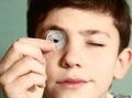 Boy preteen numismatic collector show his coin Royalty Free Stock Photo