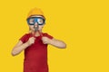 Boy in protective helmet and goggles, holding in hands pliers Royalty Free Stock Photo