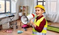 boy in protective helmet talking to megaphone