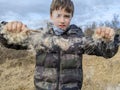 A boy pulling apart Bulrush reed mace seed into the air Royalty Free Stock Photo