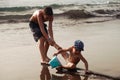 Boy pulling a brother during the game on the beach. Children have fun playing on the ocean. A fun summer vacation. Happy Royalty Free Stock Photo