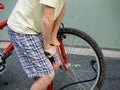 Boy pumping up a bike tire