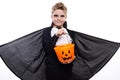 Boy with pumpkin basket dressed like vampire for Halloween party Royalty Free Stock Photo