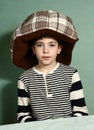 Boy put cat bed as a hat on his head Royalty Free Stock Photo