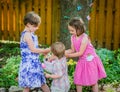 Boy Puts Egg in Girl's Easter Basket Royalty Free Stock Photo