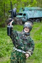 Boy raises hand with paintball gun Royalty Free Stock Photo