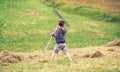 Boy raking dry hay with rake on field Royalty Free Stock Photo