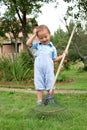 Boy raking in the garden Royalty Free Stock Photo