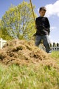 Boy raking grass Royalty Free Stock Photo