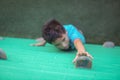 Boy reaching climbing holds on wall Royalty Free Stock Photo