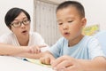 Boy reading aloud with tutorship