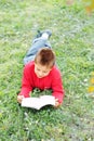 Boy reading book on grass Royalty Free Stock Photo