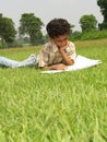 Boy reading book in grass Royalty Free Stock Photo