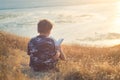 Boy reading book outside at sunset Royalty Free Stock Photo