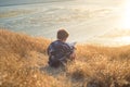 Boy reading book outside at sunset Royalty Free Stock Photo