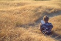 Boy reading book outside at sunset Royalty Free Stock Photo