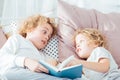 Boy reading book to brother Royalty Free Stock Photo