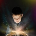 Boy is reading a magic book Royalty Free Stock Photo