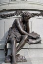 Boy reading monument detail