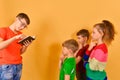 The boy reads a book, and the children listen with admiration. Big brother teaches children the sciences Royalty Free Stock Photo