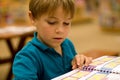 Boy reads a book at libary