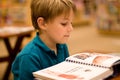 Boy reads a book at libary