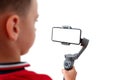 Boy is recording with a mobile phone on the gimbal Royalty Free Stock Photo