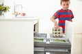 Boy Recycling Kitchen Waste In Bin