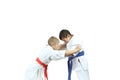 Boy with red belt are perfoming capture judogi the sportsman with blue belt