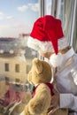 A boy in a red cap looks out the window. Royalty Free Stock Photo