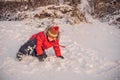 Boy in red fashion clothes playing outdoors. Active leisure with children in winter on cold days. Boy having fun with Royalty Free Stock Photo