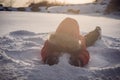 Boy in red fashion clothes playing outdoors. Active leisure with children in winter on cold days. Boy having fun with Royalty Free Stock Photo