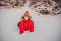 Boy in red fashion clothes playing outdoors. Active leisure with children in winter on cold days. Boy having fun with Royalty Free Stock Photo