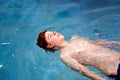 Boy with red hair enyoing swimming